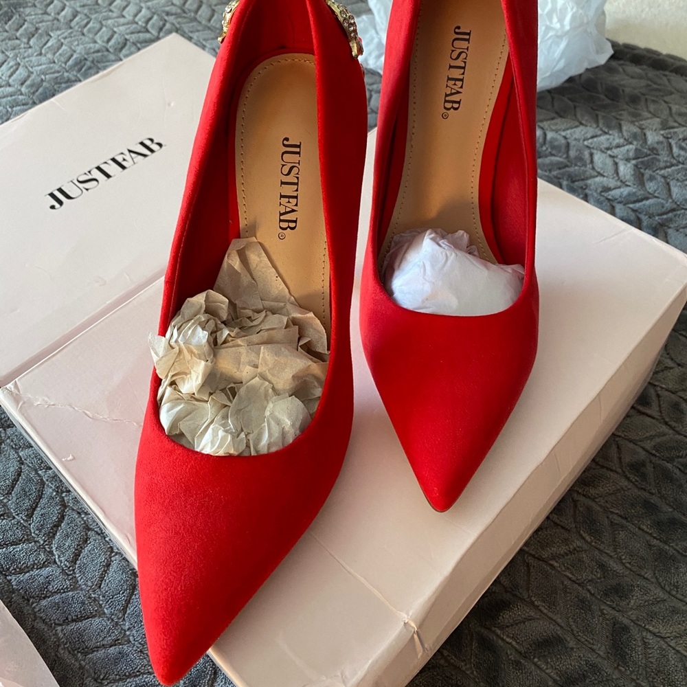 Red heels with gold details on the back.